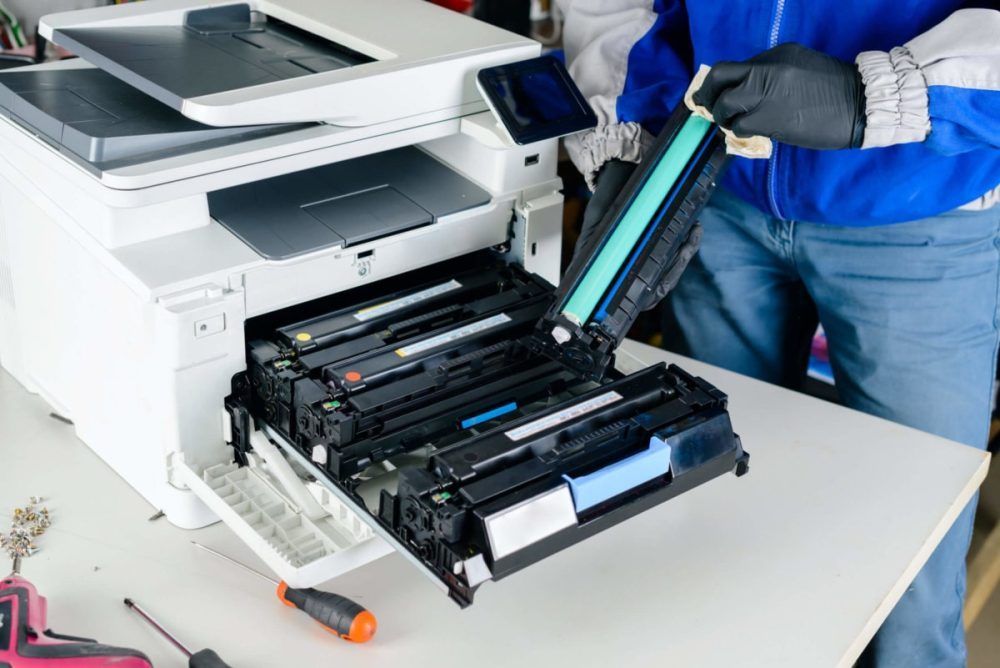 Printer World Group repair specialist servicing a printer
